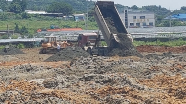 지난 15일 현장 덤프트럭이 일반폐기물인 개흙을 하차하고 있다.