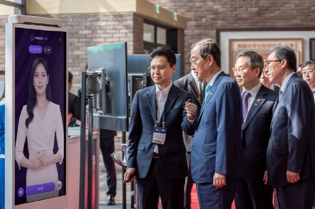 한덕수 국무총리와 이종호 과학기술정보통신부 장관이 대화형 AI 휴먼의 시연을 보기 위해 이스트소프트 부스에 방문하고 있다