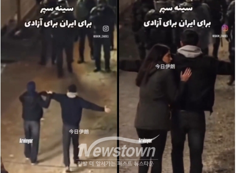 최근 온라인에 유포된 한 영상에 한 커플로 추정되는 사람들이 손을 잡고 팔을 뻗어 군인과 경찰의 총구를 마주하는 모습이 담겨 있다. /X